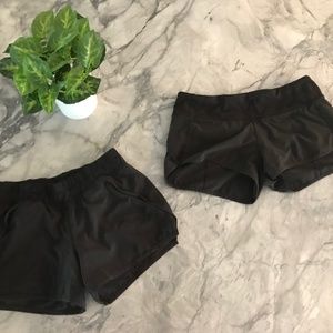 Two pairs of black athletic Lululemon shorts